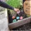 Student adding ceramic bee baths to the school herb garden. Herbs in background. Colourful ceramic funnel shaped bee baths