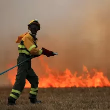 A firefighting watering a fire