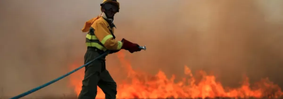 A firefighting watering a fire